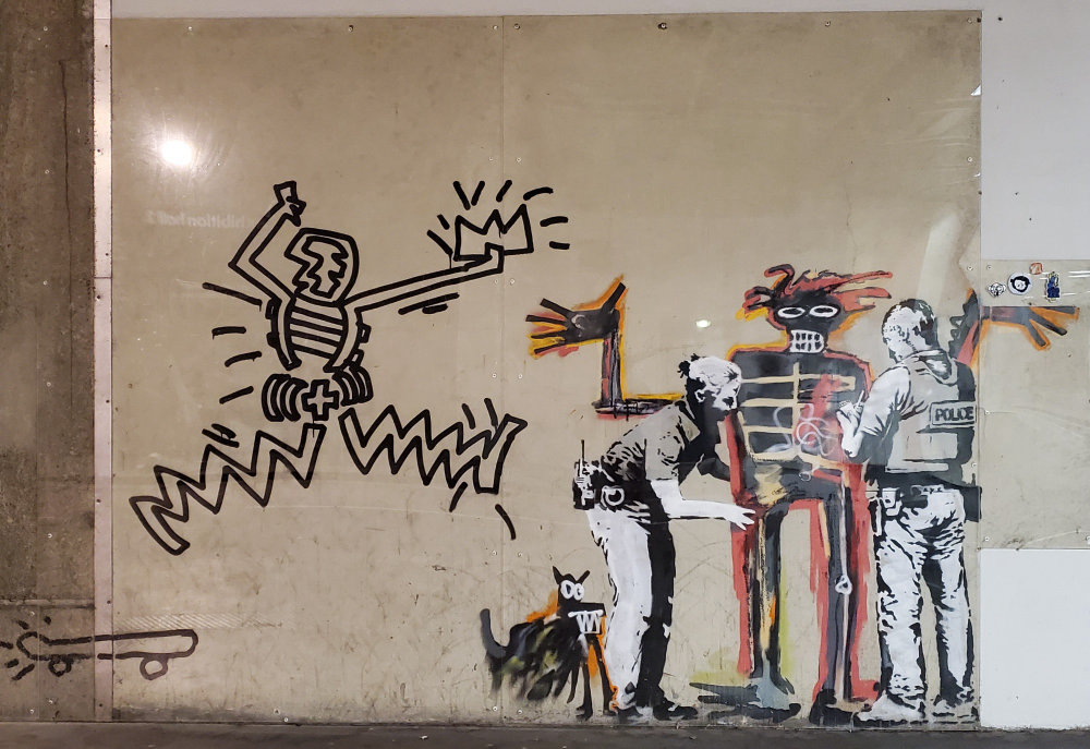mural in  by artist Banksy. Tagged: Jean-Michel Basquiat